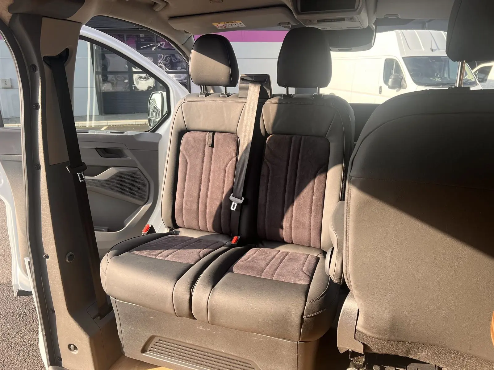 Double front passenger seat upholstered in brown leather-look material with ribbed suede-effect centre panels.