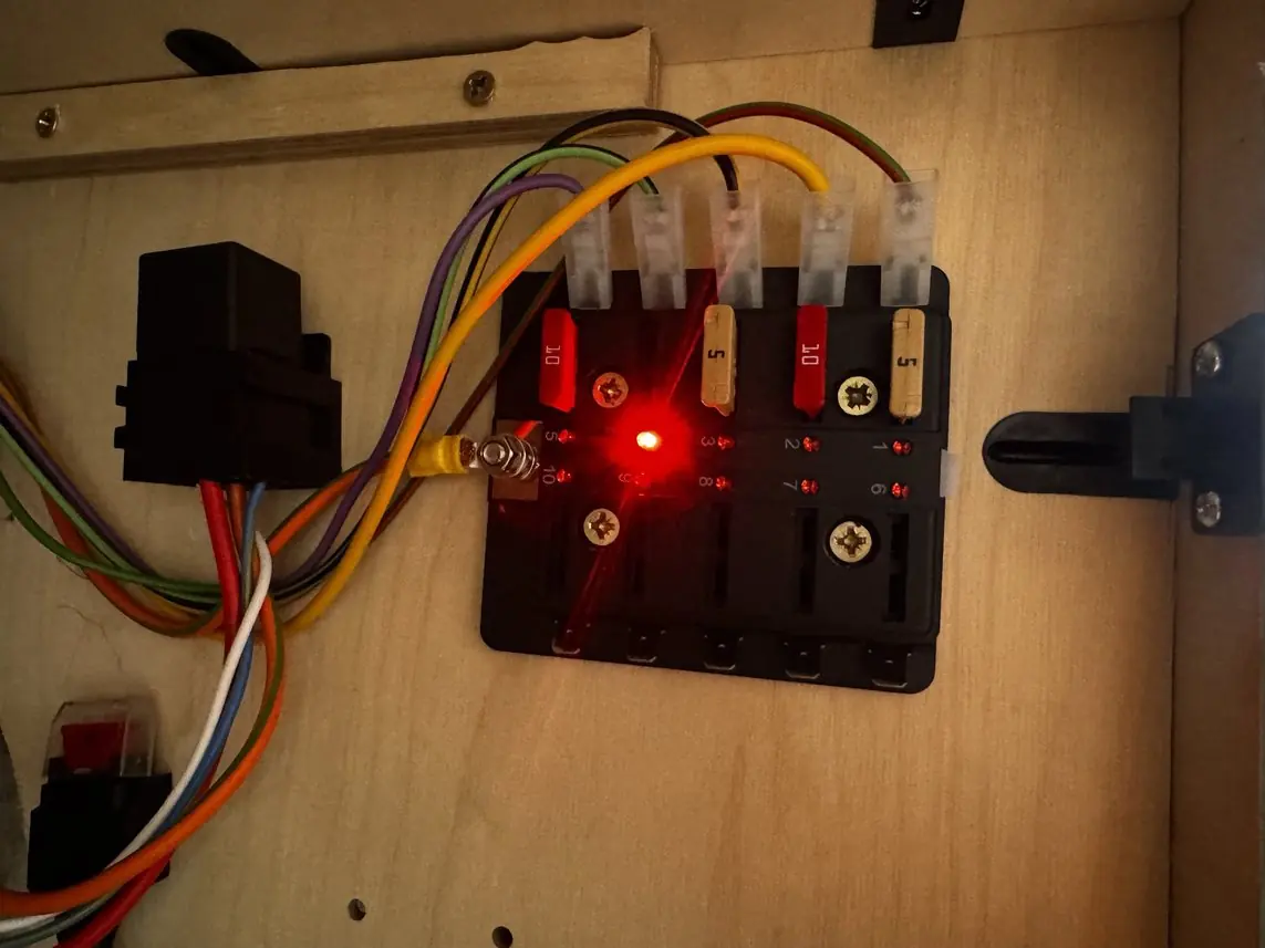 A red light glows beside the fuse that has gone