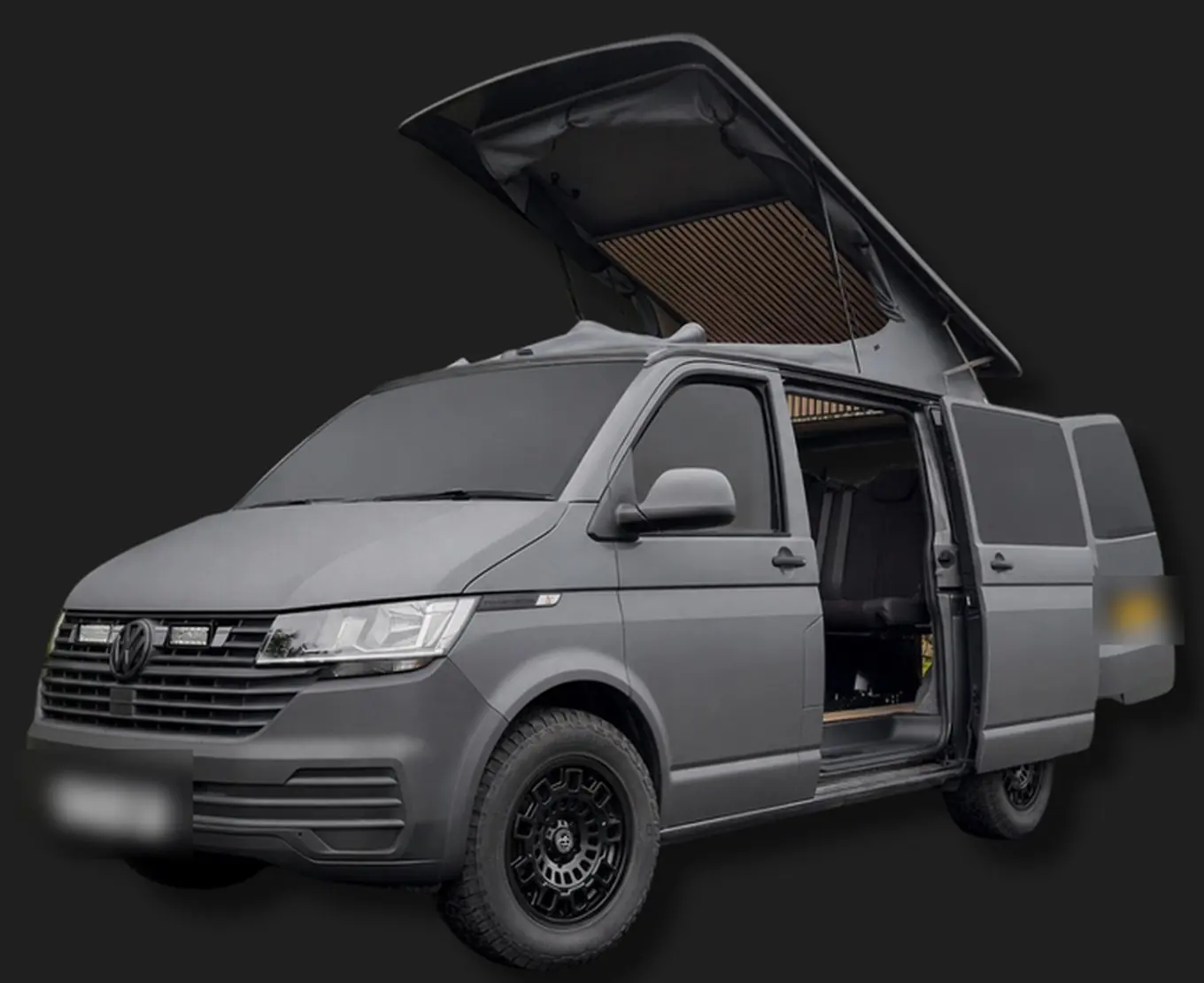 Grey VW camper with the pop-top raised and the side door open