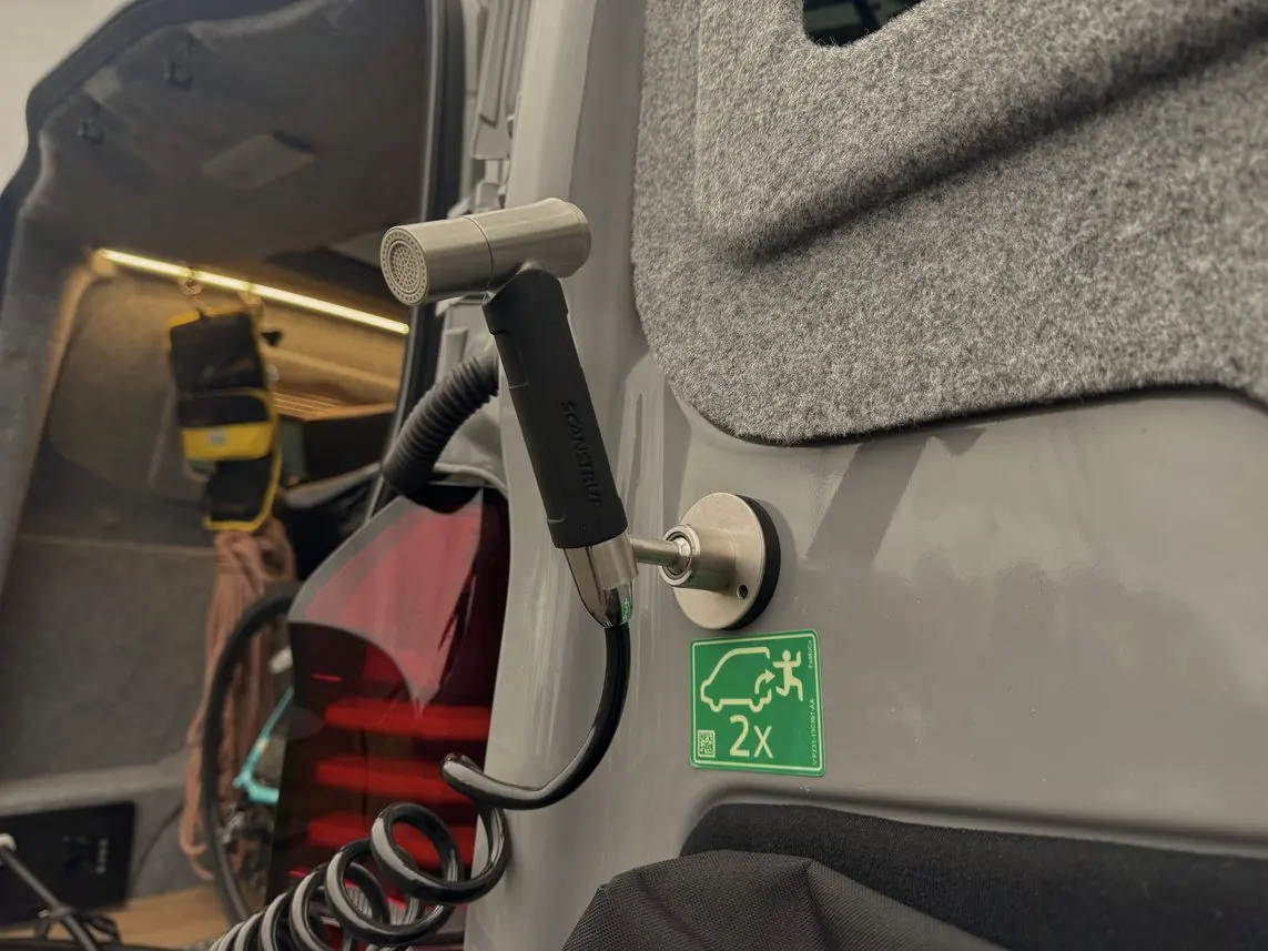 B: water inlet and outlet under the rear of the van
