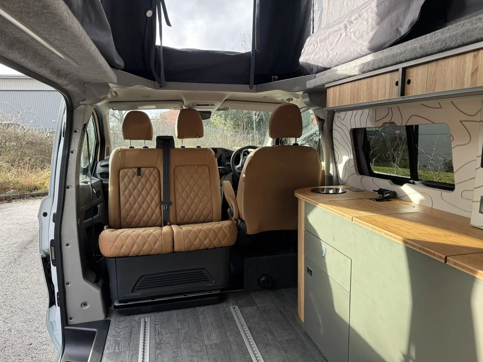 Tan quilted cab seats and a pale green kitchen with a contour wall panel