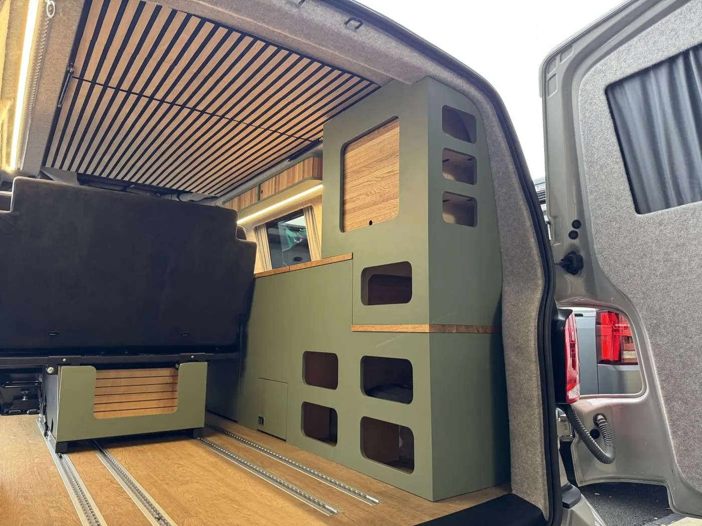 Tourer module: a tall green storage unit with cubby holes at the rear of the van