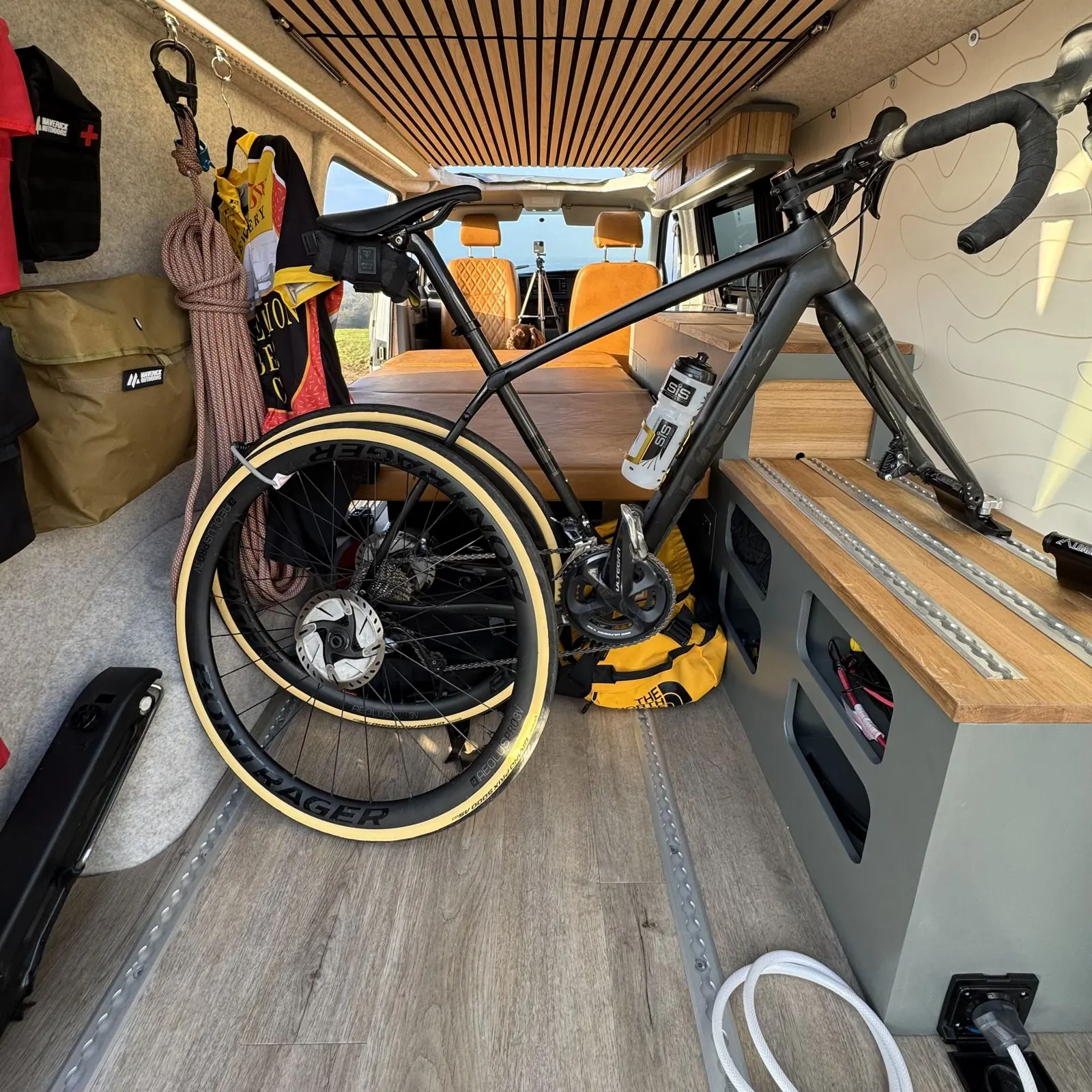 Expedition rear cabinet with rails, a road bike on a fork mount and kit along the wall